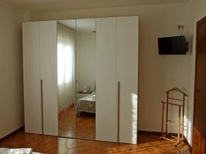 a large white cabinet with a mirror in a room at Appartamento Giotto - Free Parking in Livorno