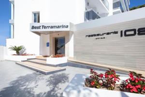 a hospital building with flowers in front of it at Hotel Best Terramarina in La Pineda