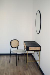 una mesa y una silla junto a un espejo en Apartamenty Centrum, en Krotoszyn