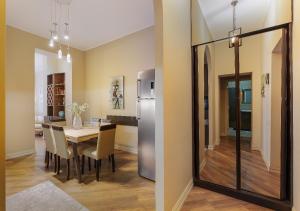 a kitchen and dining room with a table and a refrigerator at HD Dream Apartment in Tbilisi City