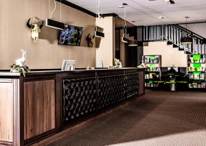 a bar in a store with a staircase in the background at Hotel Texas*** in Żory