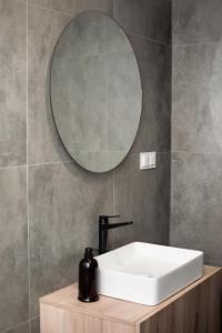 a bathroom with a sink and a mirror at Apartamenty Centrum in Krotoszyn