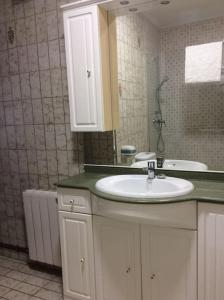 a bathroom with a sink and a mirror at Apartamento en la Playa de Somo. in Somo