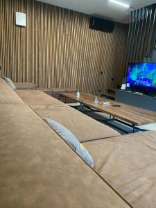 a row of beds in a room with a tv at Casa Viilor in Chişinău