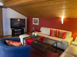 a living room with a couch and a tv at Haus Irmgard in Bad Endorf