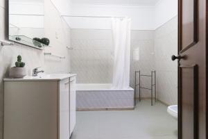 a bathroom with a tub and a sink and a shower at Sintra Classic Villa with Pool by Homing in Sintra
