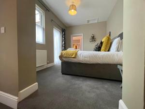 a bedroom with a large bed and a window at 2-Bed Victorian Elegance in Chester