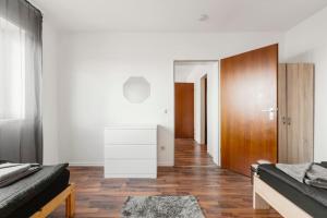 um quarto com 2 camas e piso em madeira em MaliDu Apartment Krefeld Düsseldorf em Krefeld
