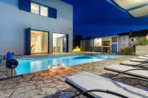 a swimming pool in the backyard of a house at Holiday home Blue Sky in Zaostrog +101 photos