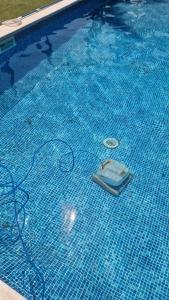 a swimming pool with a cell phone in the water at Villa Maresme & Villa Rosa in Mataró