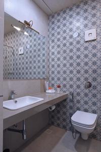 een badkamer met een wastafel en een toilet bij juSTa Rudra Resort & Spa in Kolad