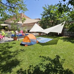 two tents sitting on the grass in a yard at E-Tekergők Háza in Bükkzsérc