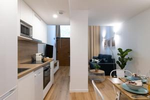 a kitchen and living room with a table in a room at DormForYou Alameda 12 Apartment in Valencia +15 photos