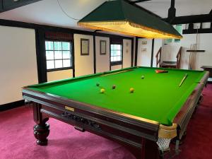 a pool table with balls on it in a room at Yu’s Guest House in Sevenoaks