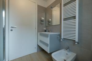 a bathroom with a white toilet and a sink at BergamoCityCenter 01 in Bergamo