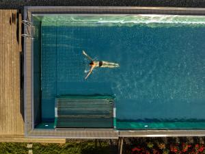 a person swimming in the water in a swimming pool at Hotel Franks in Oberstdorf