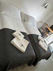 a bed with two towels on top of it at Villa Magdalena apartments & rooms in Maribor