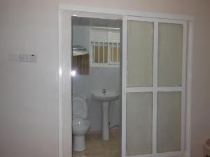 a bathroom with a toilet and a sink at Psalms Motel in Entebbe