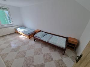 a room with two beds and a window at Apartmán EMILY in Brezno