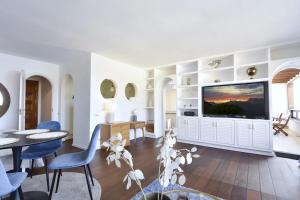 a living room with a large flat screen tv at 100 m2 Penthouse on the beach. in Patalavaca