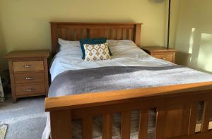 a bedroom with a bed with two night stands at Brindles in Sissinghurst