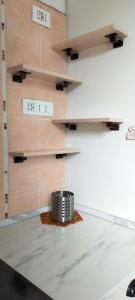 a room with a table and a wall with shelves at Appartamento Rosa in Marghera