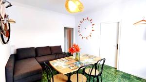 a living room with a couch and a table with chairs at THE ROOM - APARTMENT IN LLORET in Lloret de Mar