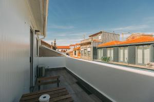 a view from the balcony of a building with a bench at Aparthotel Oporto Sol in Porto