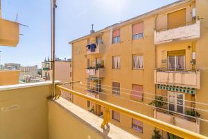 a view from the balcony of a yellow building at Castelletto Roomy & Functional Flat in Genova