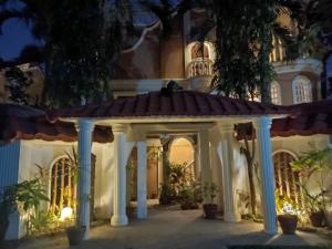 a house with a gazebo at night at Blue Crystal Beach Resort in Puerto Galera