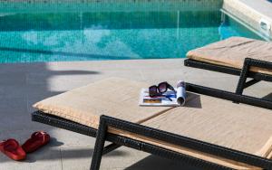 un par de gafas y un libro junto a una piscina en Holiday home Blue Stone, en Zaostrog