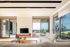 a living room with a couch and a tv at Centro Golden View Villa in Chania
