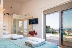 a bedroom with a bed with towels on it at Centro Golden View Villa in Chania