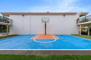 a basketball hoop in front of a building at Ramada by Wyndham Kissimmee Gateway - Free Theme Park Shuttle in Orlando