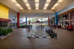 a room with a chessboard in the middle of a building at Ramada by Wyndham Kissimmee Gateway - Free Theme Park Shuttle in Orlando