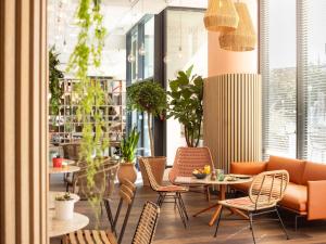 a restaurant with chairs and a table in a room at ibis Marseille Centre Euromed in Marseille