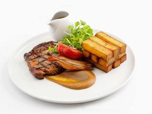a plate of food with steak and french fries at Sofitel London Gatwick in Horley