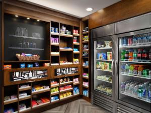 a grocery store with a refrigerator and lots of food at Hampton Inn Troy in Troy