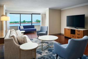 a living room with a couch and a flat screen tv at Hilton New Orleans Riverside in New Orleans