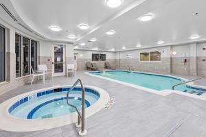 a pool in a hotel room with a swimming pool at Hilton Garden Inn Syracuse in East Syracuse