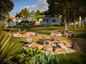 a group of picnic tables and chairs in a yard at Boho Club in Marbella