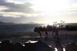 a group of people playing soccer on the beach at Deva Beach Resort Samui in Choeng Mon Beach