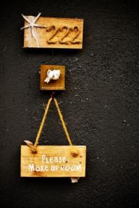 a wooden sign that says please make up room at Deva Beach Resort Samui in Choeng Mon Beach