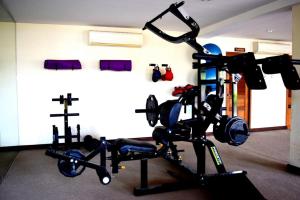 a room with a gym with a man on a machine at Deva Beach Resort Samui in Choeng Mon Beach