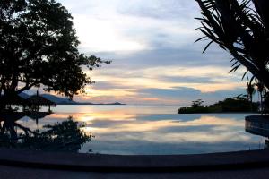 a view of the ocean from a resort swimming pool at Deva Beach Resort Samui in Choeng Mon Beach