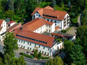 an overhead view of a large white building with a red roof at Hotel Zur Post in Pirna