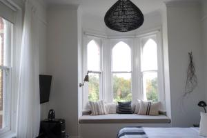 a window seat in a white room with pillows at Flash Jacks of Gundagai in Gundagai