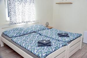 a bed with two pillows on it in a bedroom at Penzion u Vodníka in Třeboň +14 photos