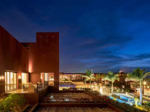 a view of a building at night at Mövenpick Resort & Spa Tala Bay Aqaba in Aqaba