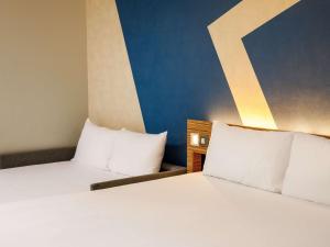 Postel nebo postele na pokoji v ubytování ibis budget London Heathrow Central